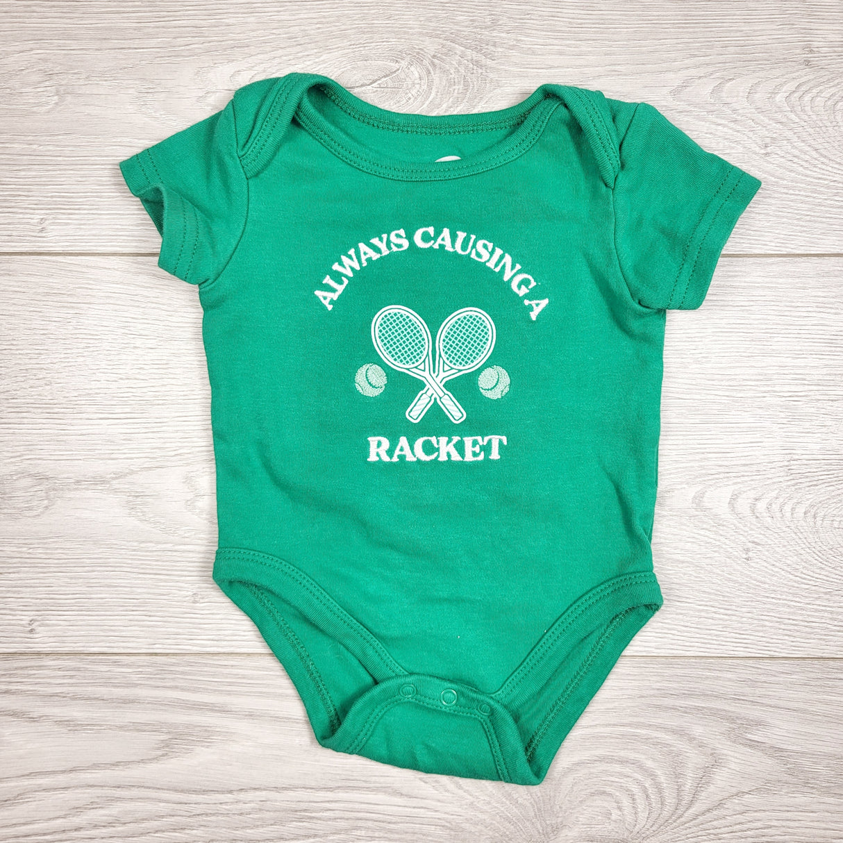 The Littlest green "Always Causing a Racket" bodysuit. Size 0-3 months