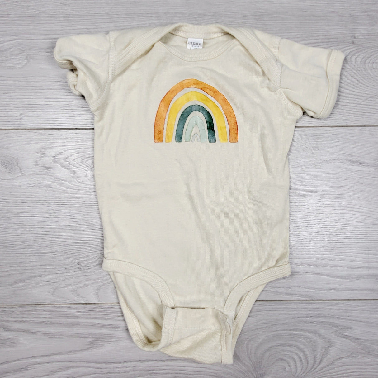 Beige custom made rainbow bodysuit. Size 6 months