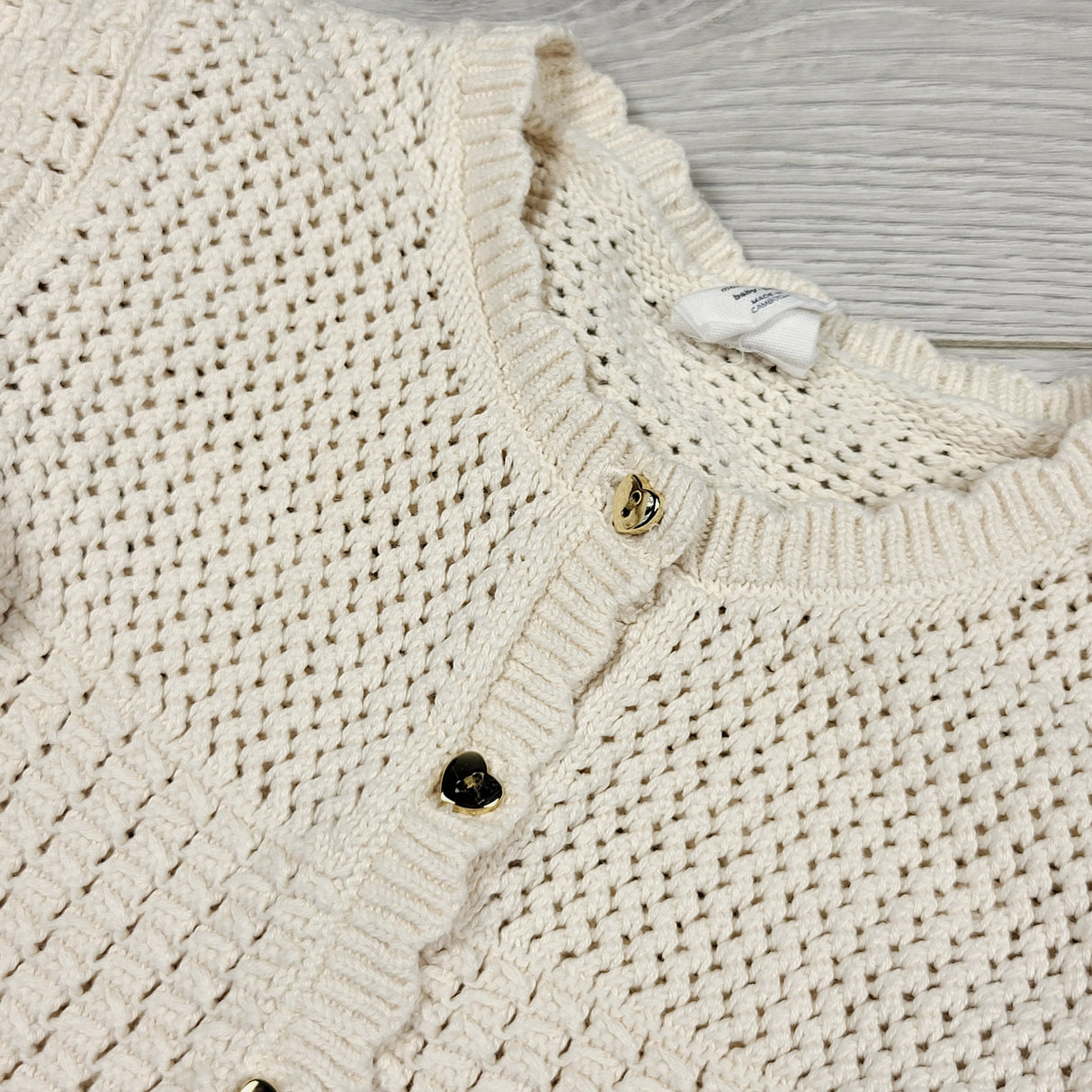 H and M cream coloured knit sweater with heart buttons. Size 6-12 months