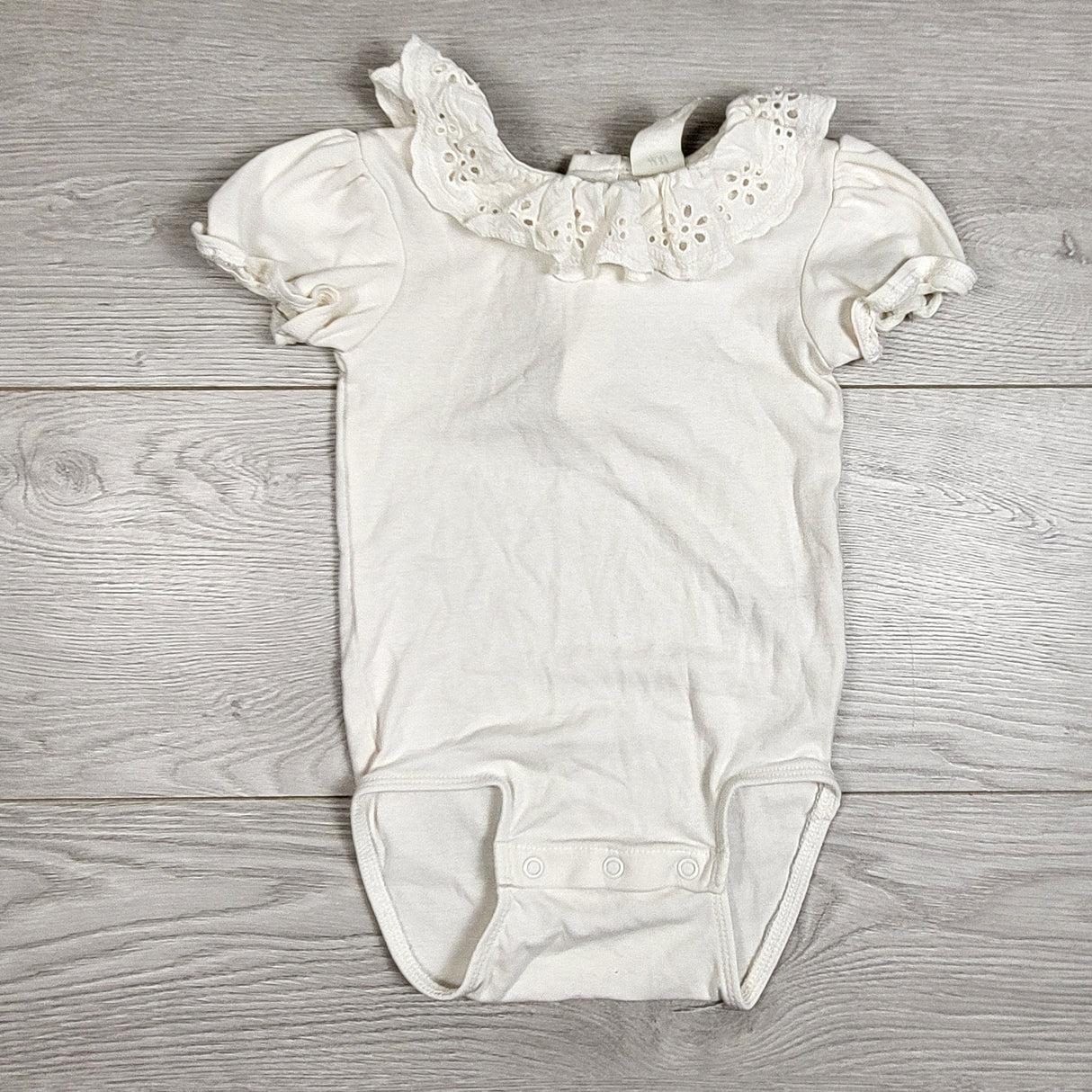 H and M white bodysuit with eyelet collar. Size 12-18 months