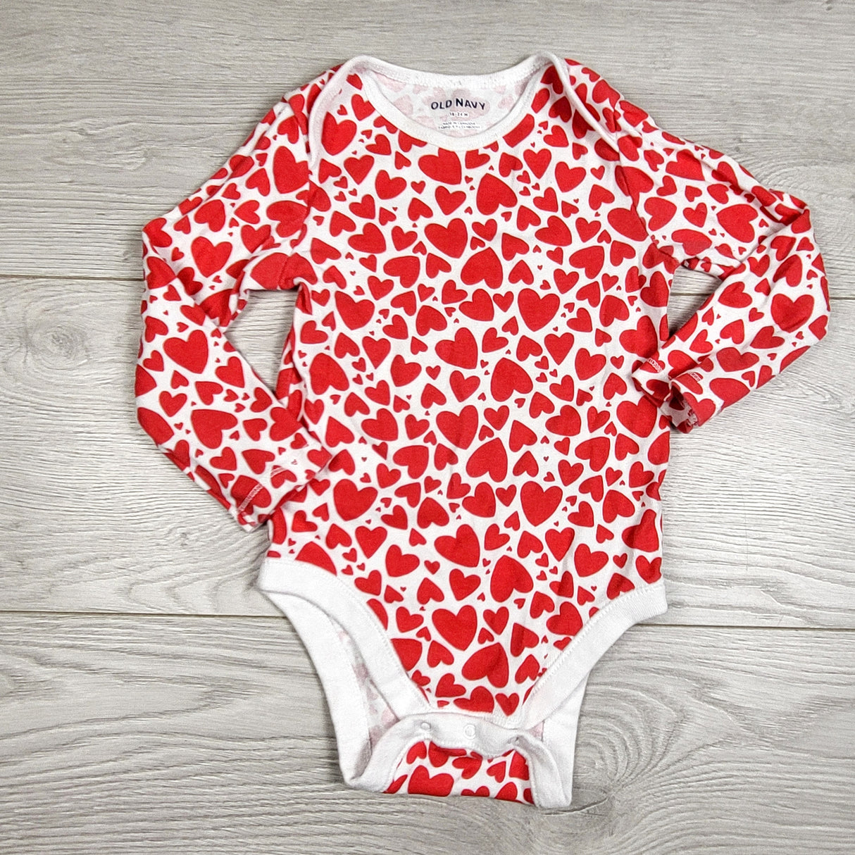 Old Navy white and red heart patterned bodysuit. Size 18-24 months