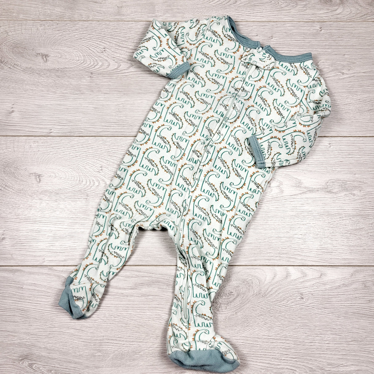 The Peanutshell pale green zippered cotton sleeper with dinosaurs. Size 6 months