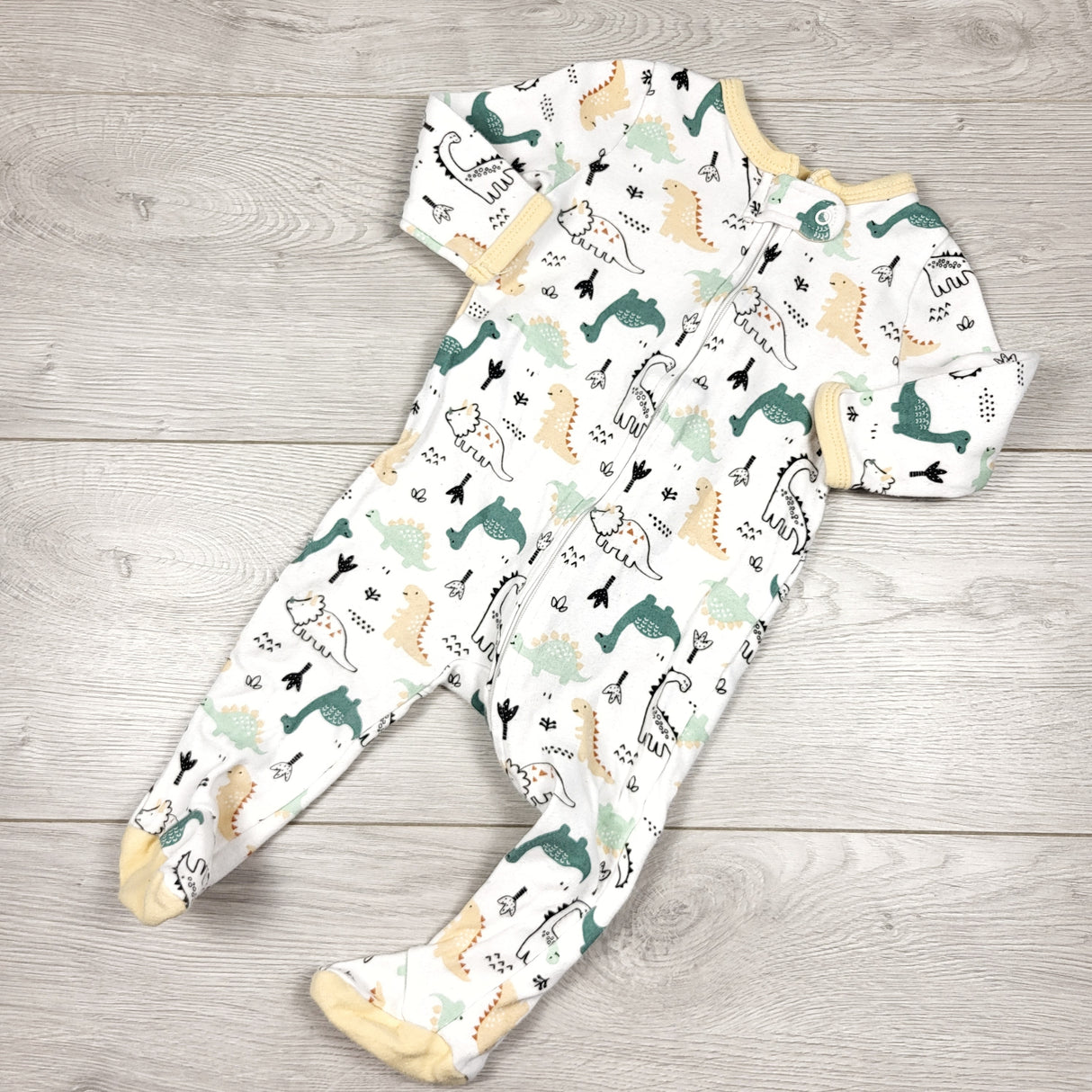The Peanutshell white and yellow zippered cotton sleeper with dinosaurs. Size 6 months