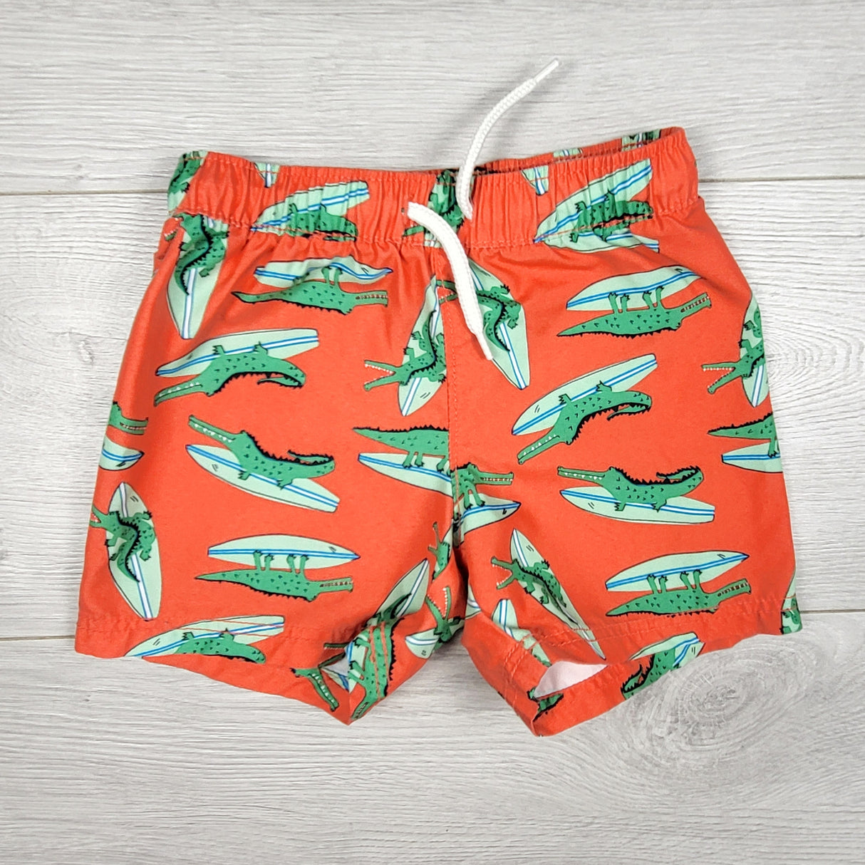 Old Navy reddish-orange alligator swim shorts. Size 12-18 months