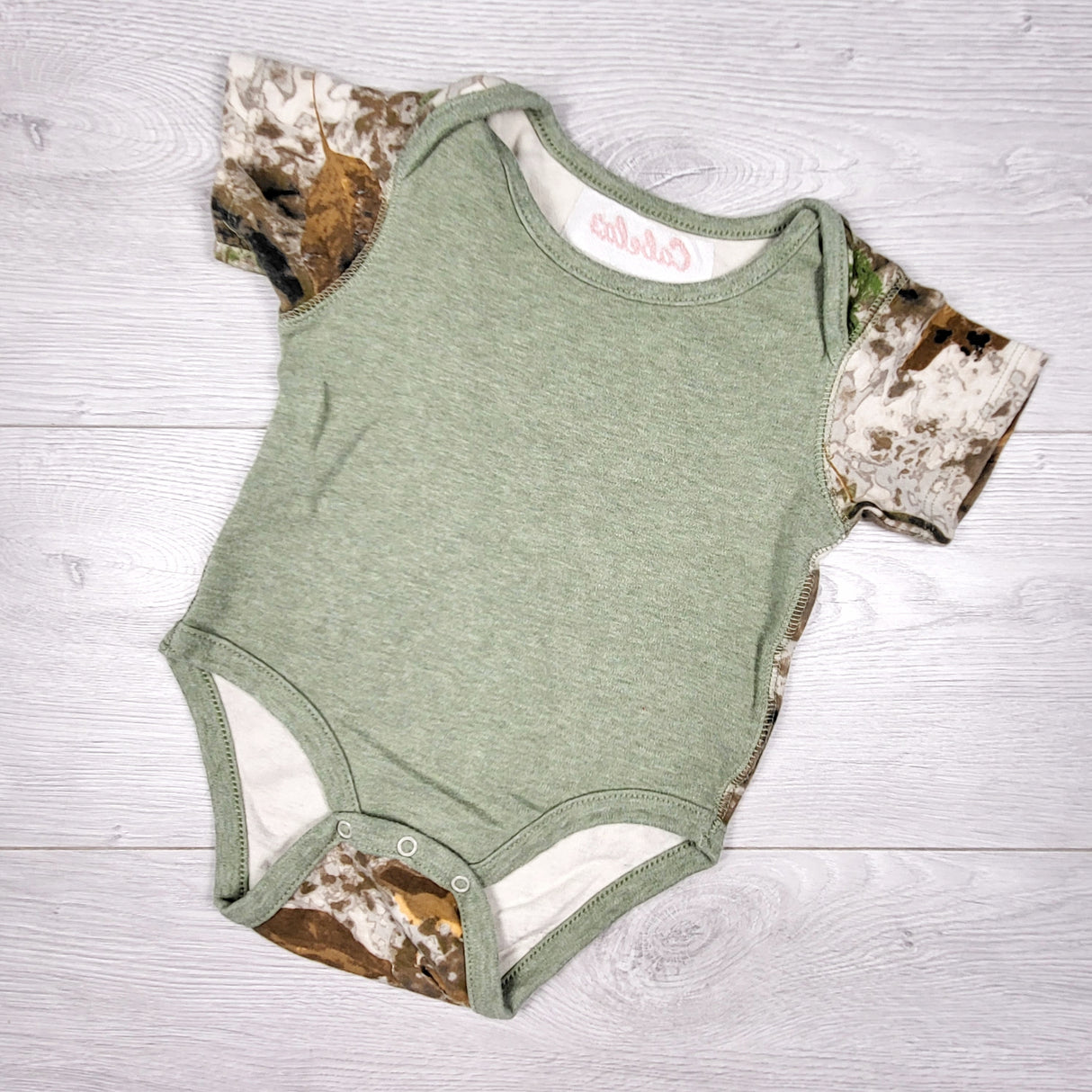 Cabela's green bodysuit with camouflage trim. Size 12-18 months