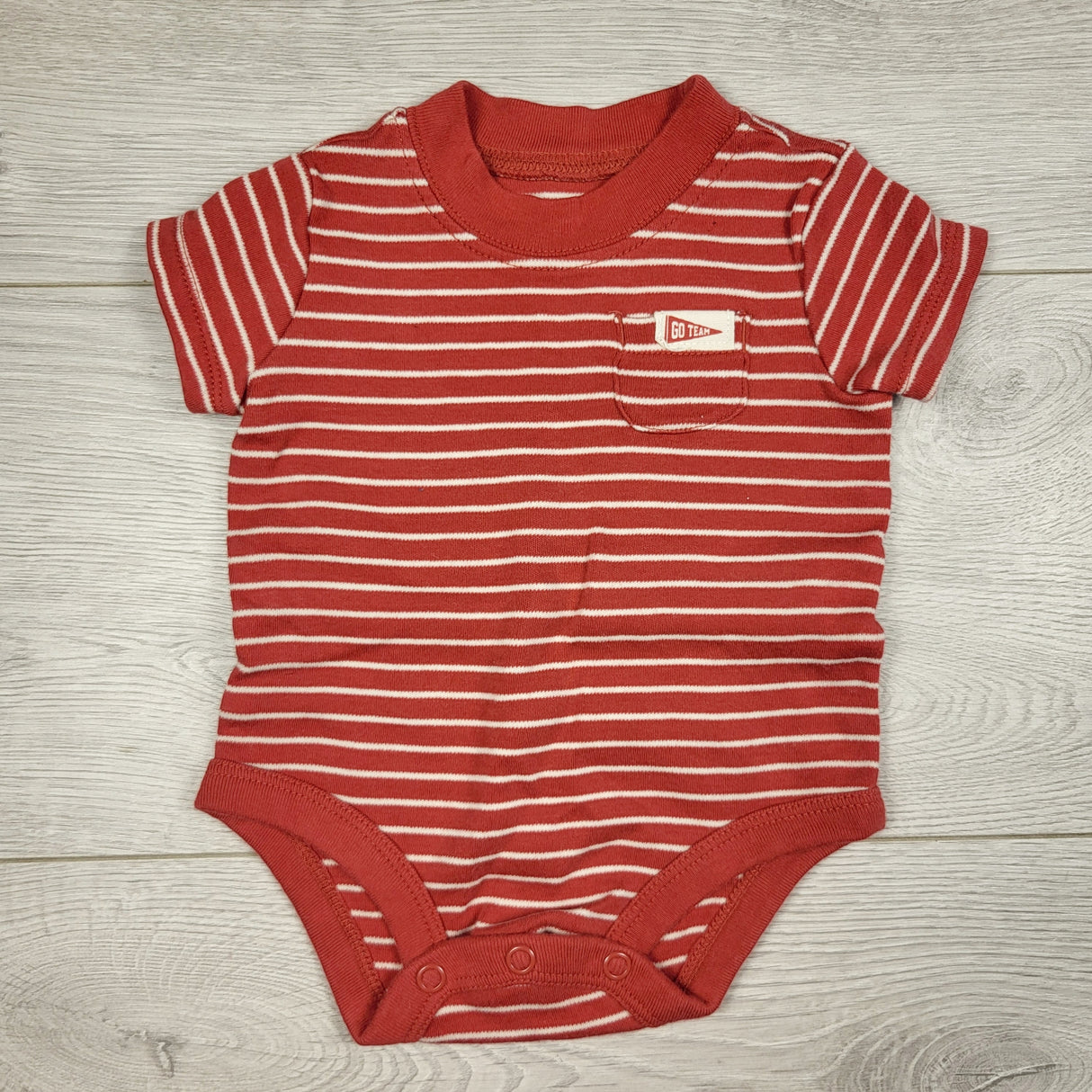 Child of Mine rust coloured striped bodysuit. Size 0-3 months