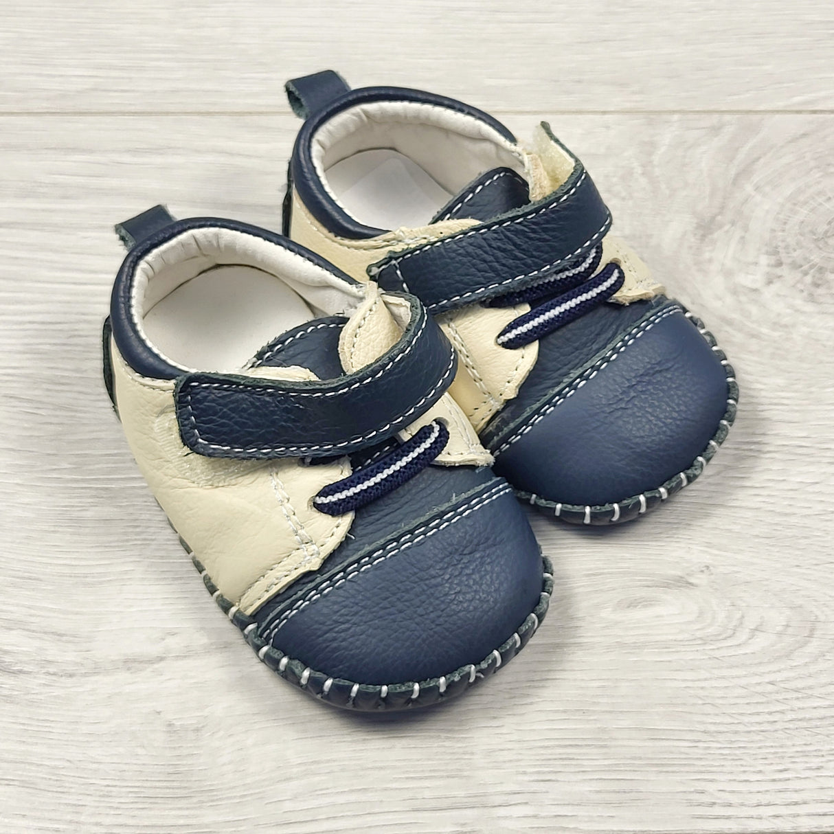 Beige and navy soft soled leather shoes. Sizes like 6 months