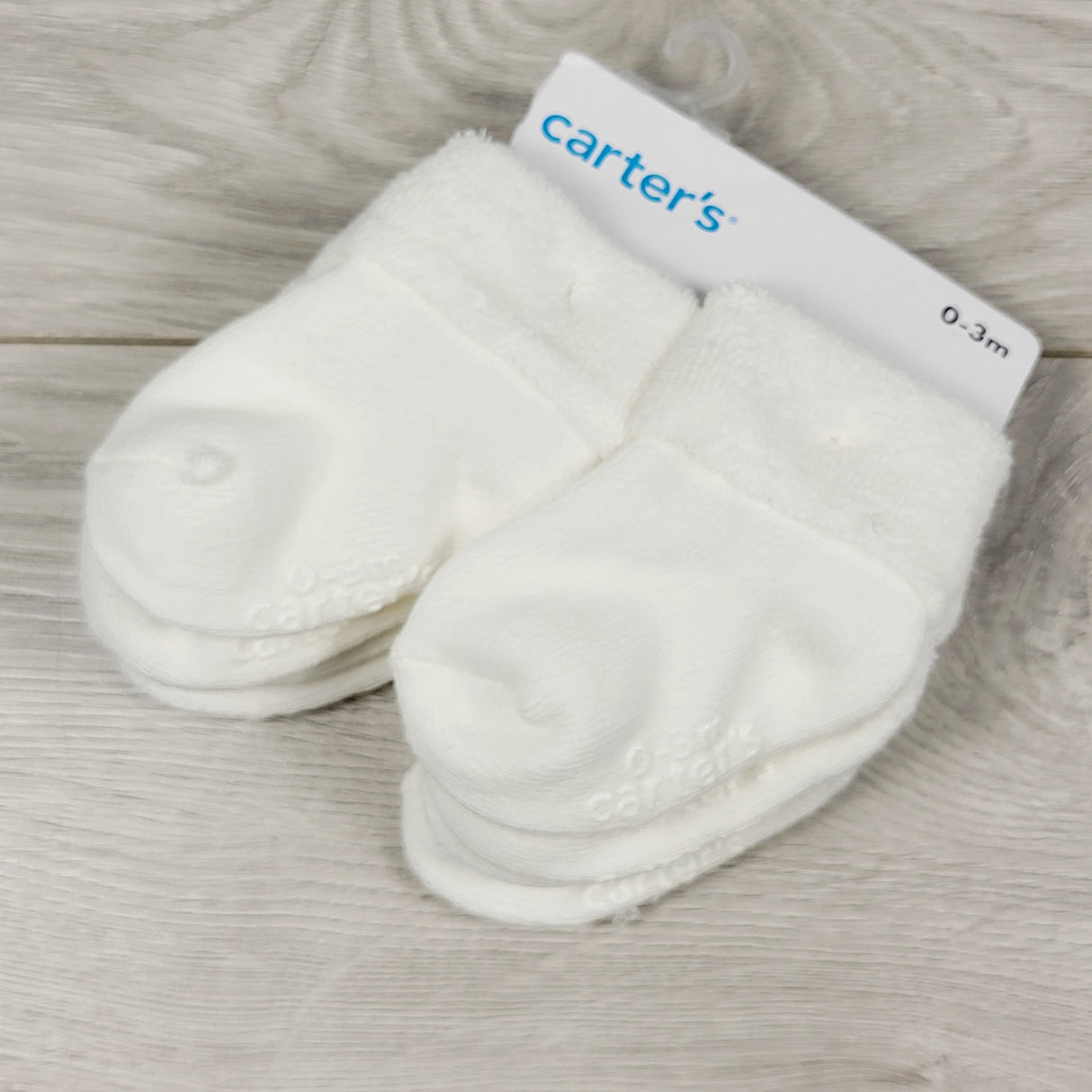 NEW - Carters white 8pc sock set. Size 0-3 months