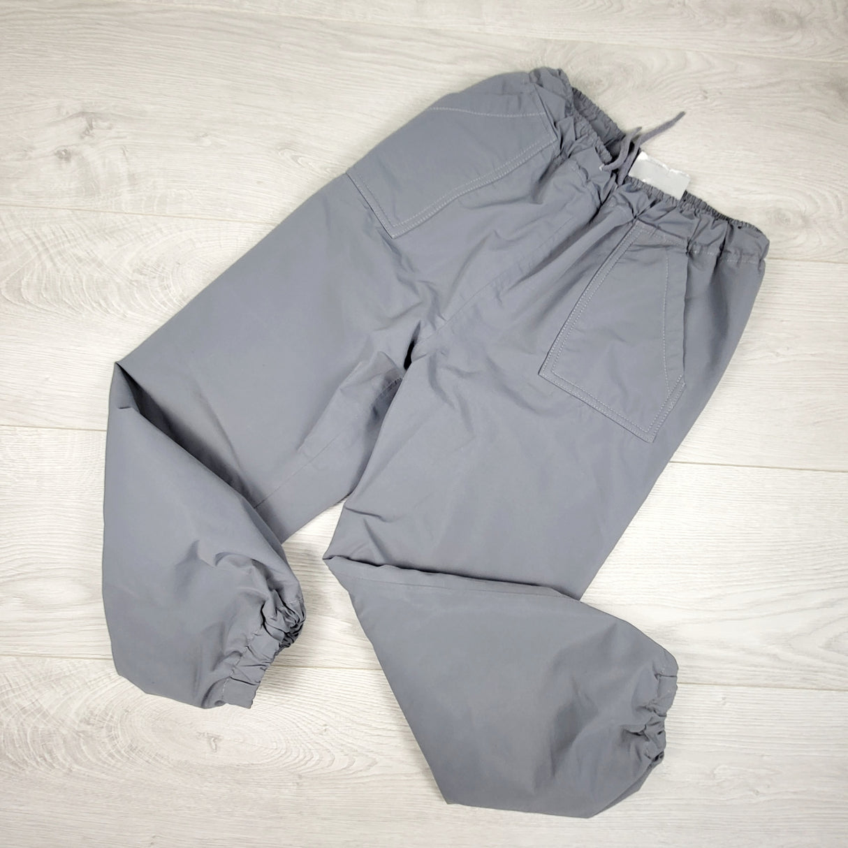 Jan and Jul grey fleece lined rain pants. Size 6