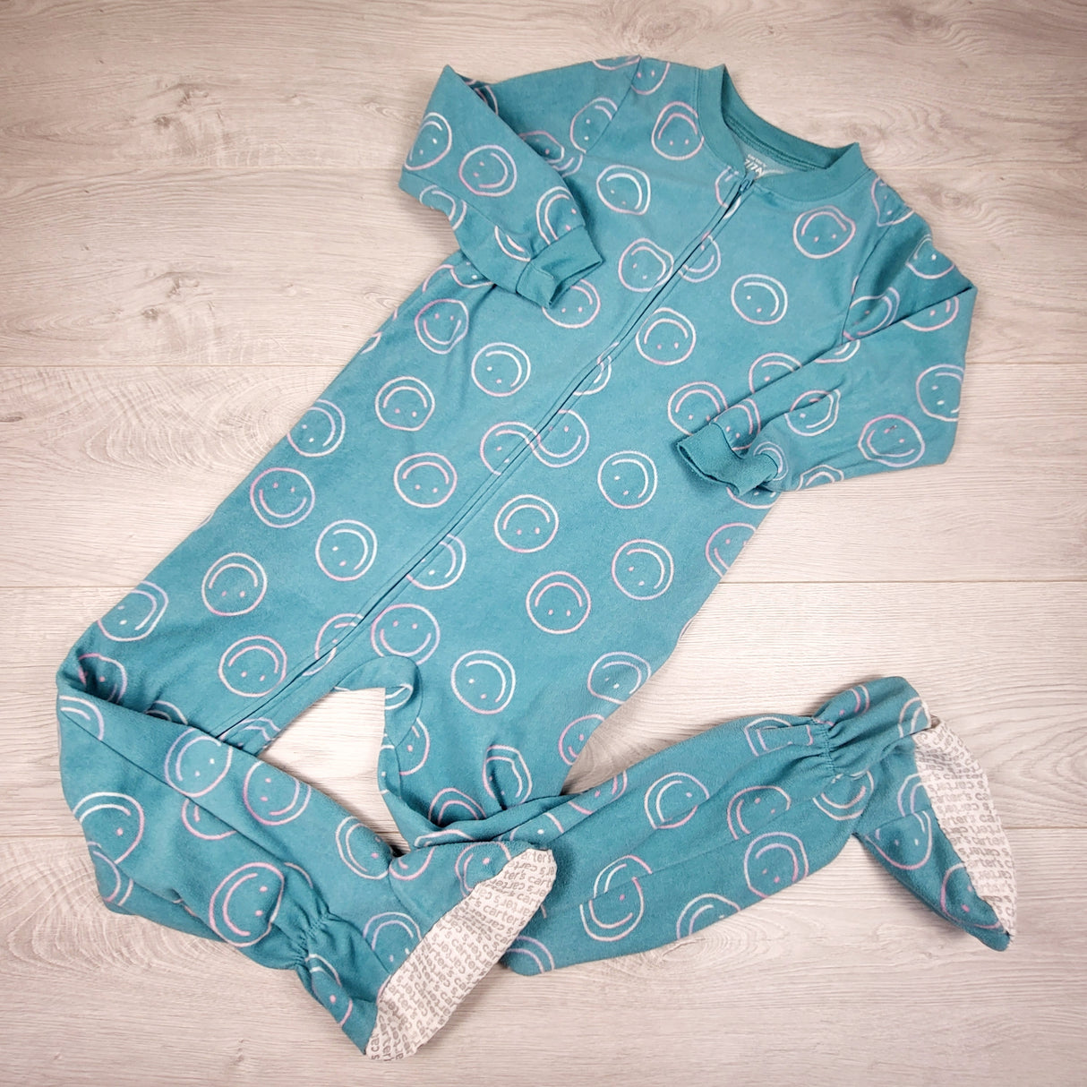 Carters teal zippered fleece sleeper with smiley faces. Size 7