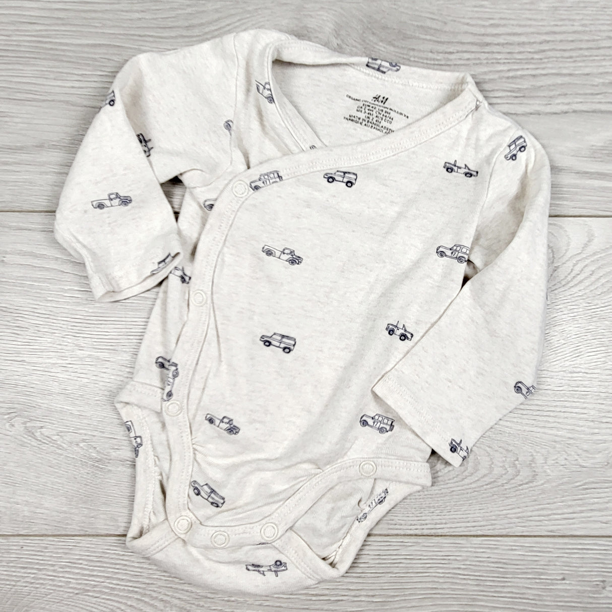 H and M wrap style bodysuit with jeeps. Size 2-4 months