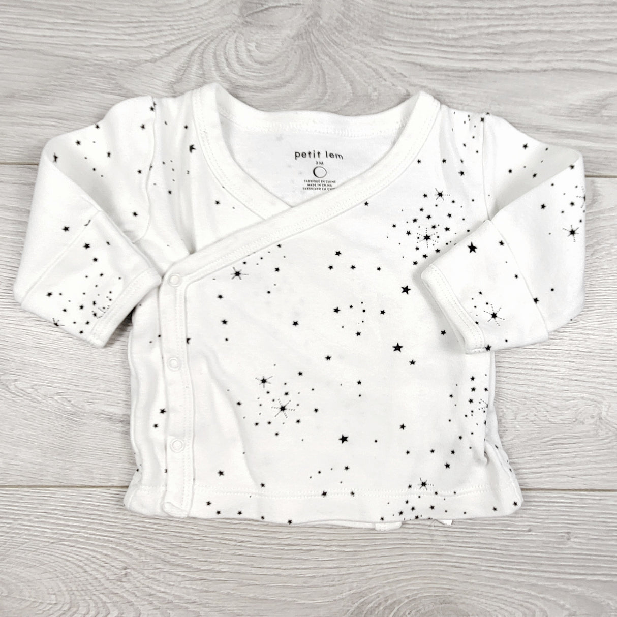 Petit Lem white wrap style top with stars. Size 3 months