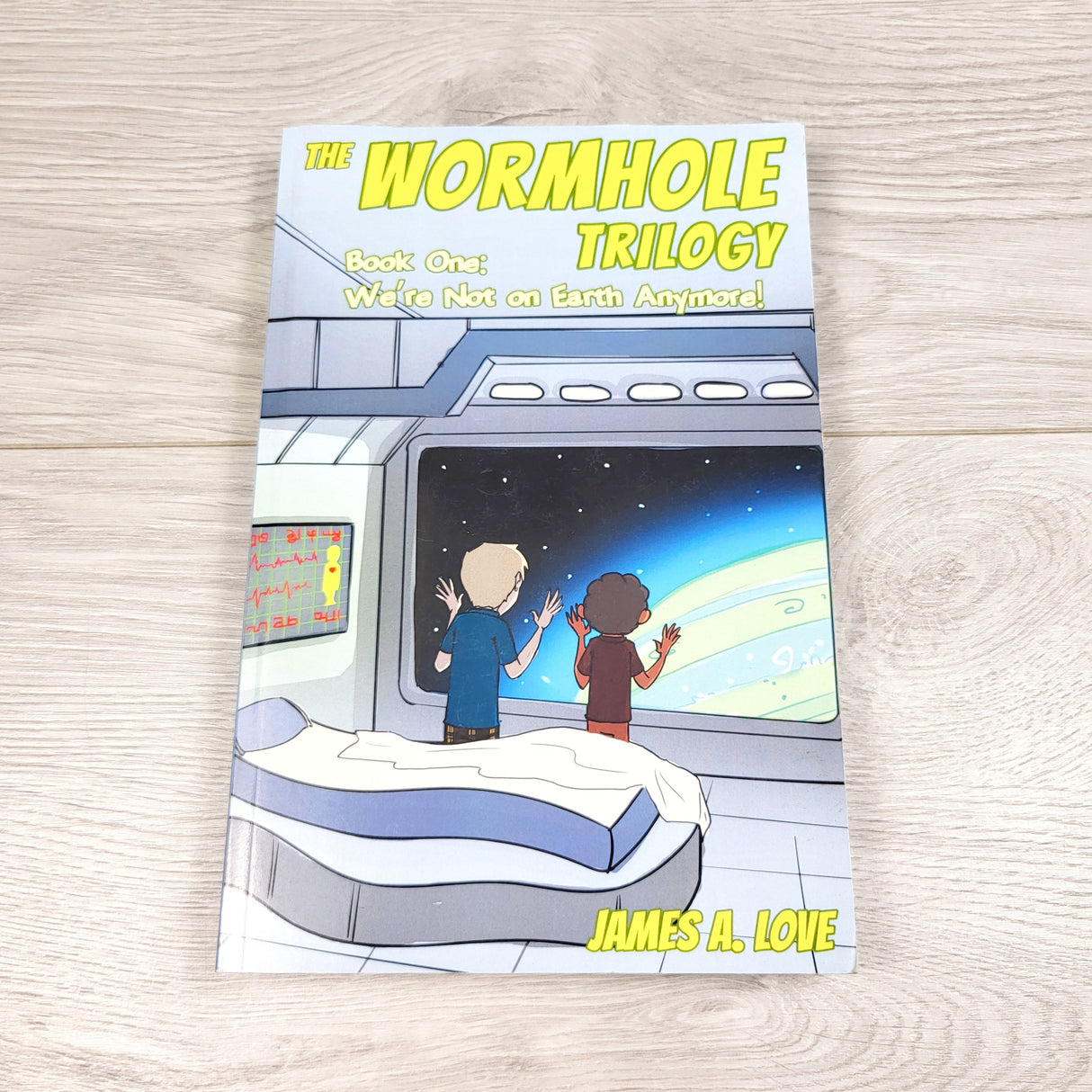 The Wormhole Trilogy: Book 1, We're Not on Earth Anymore. Soft cover chapter book