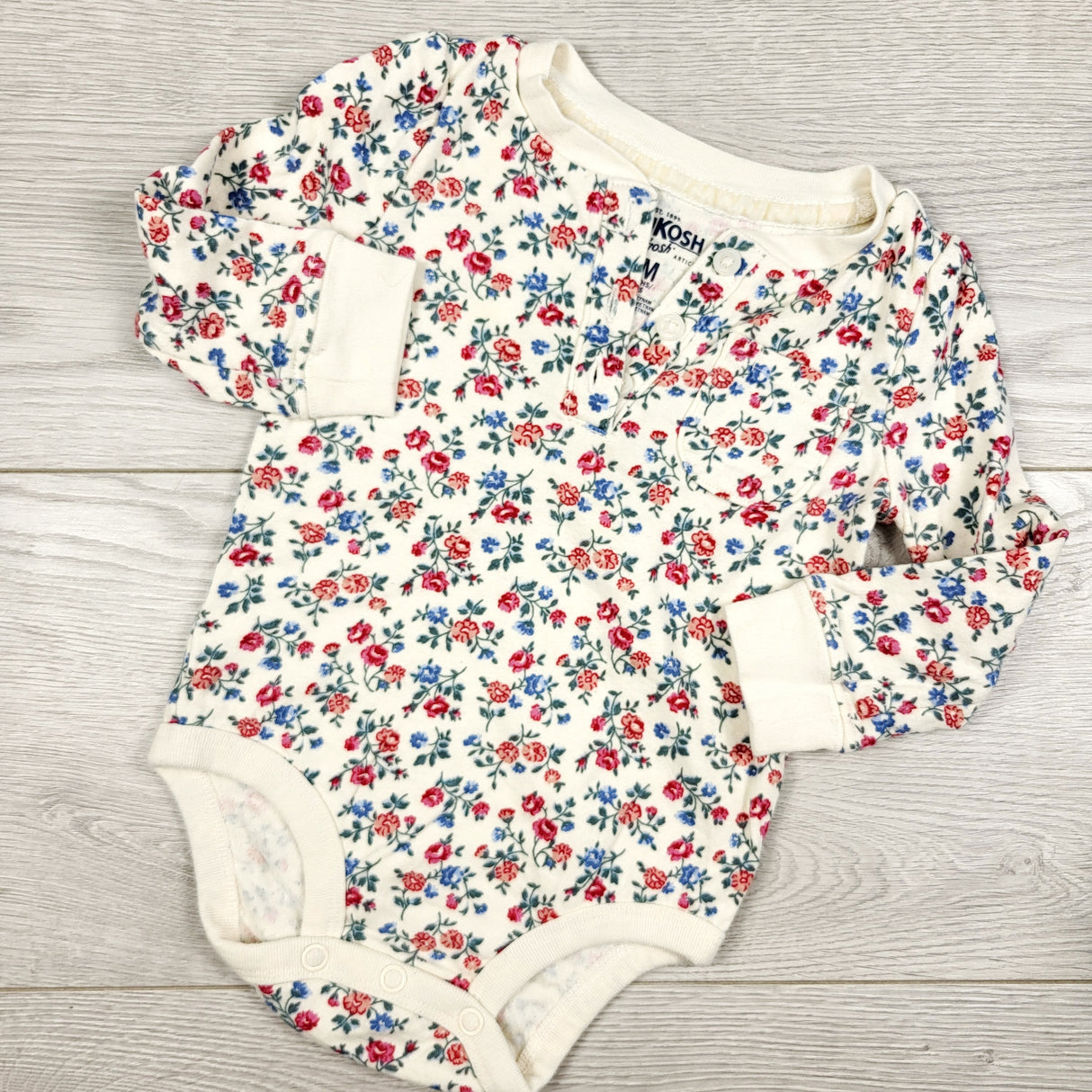 Oshkosh floral print long sleeve bodysuit. Size 9 months