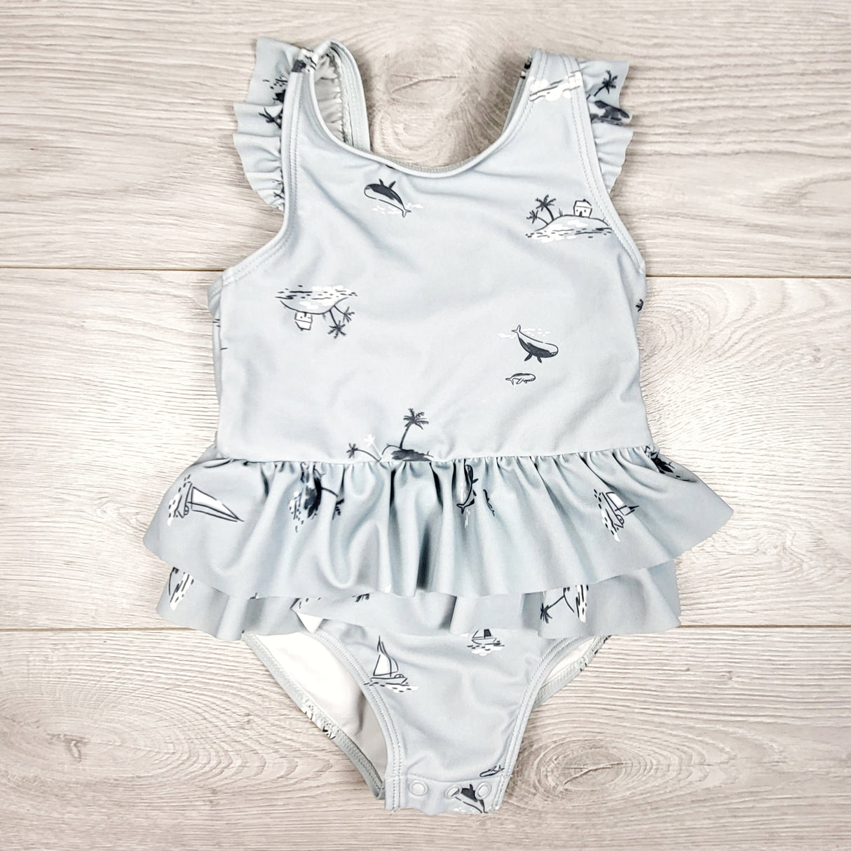 Carters blue-grey one piece swimsuit with whales and islands. Size 18 months
