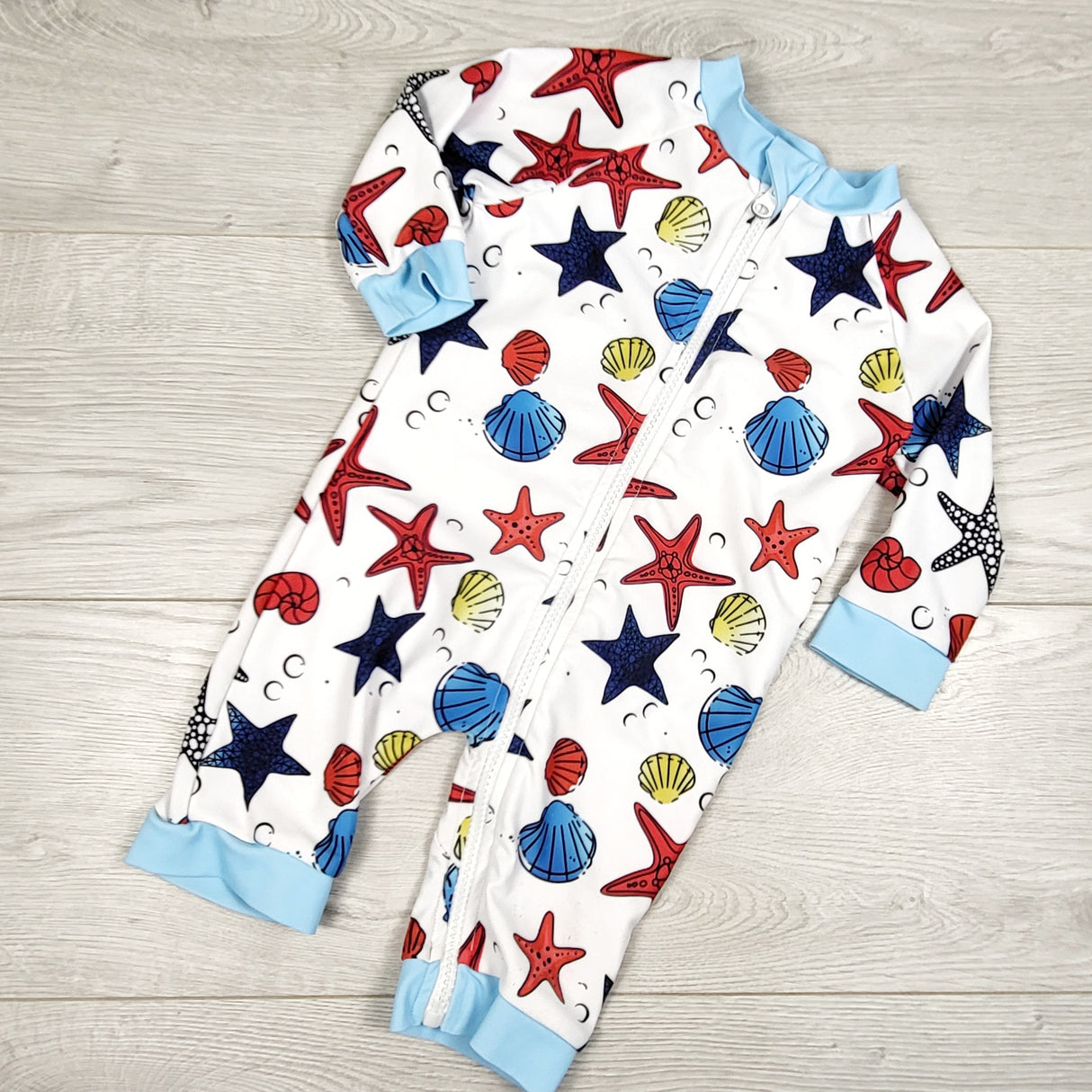 Bonverano one piece rash guard with seashells. Sizes like 12-18 months