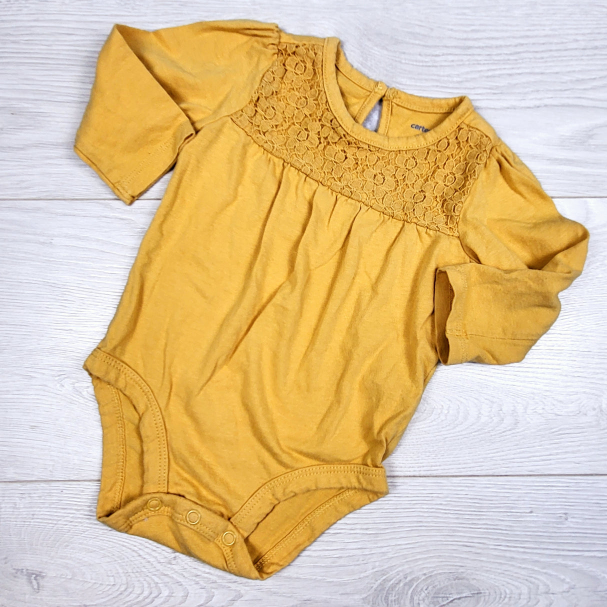 Carters golden yellow bodysuit with lace detail. Size 6 months