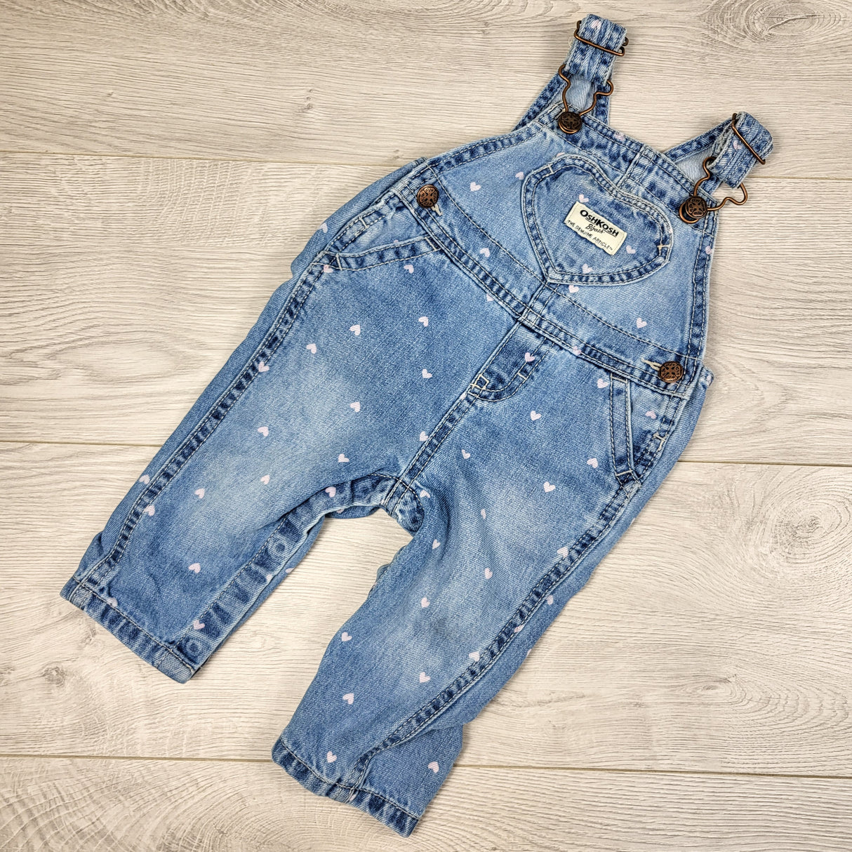 Oshkosh denim overalls with heart pattern and heart pocket. Size 6 months