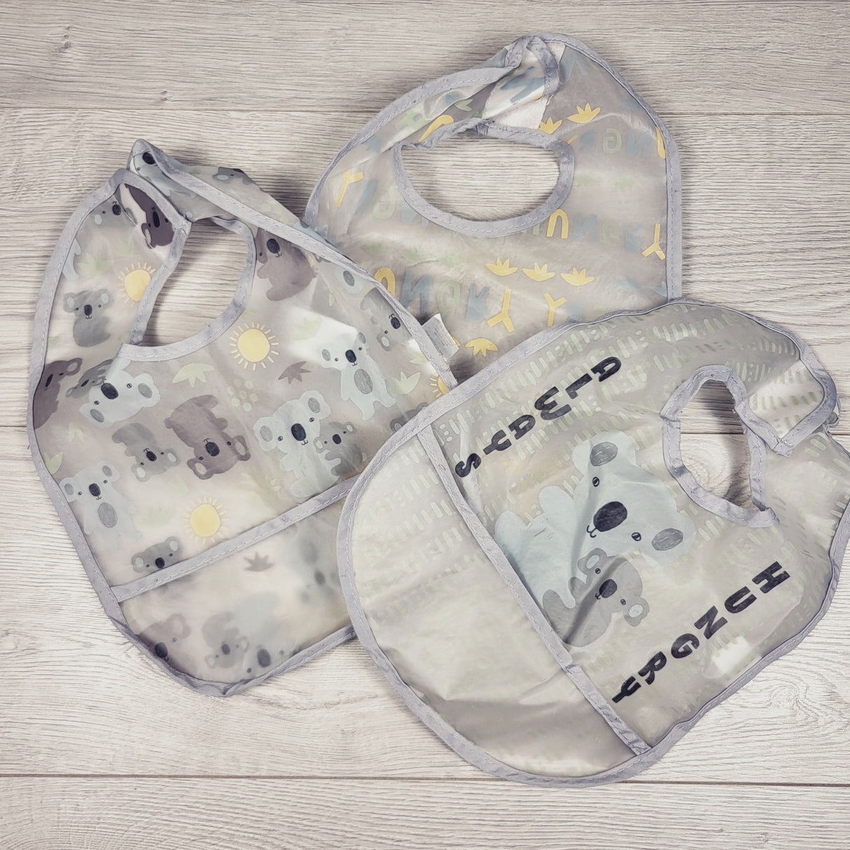 Grey koala themed plastic bibs