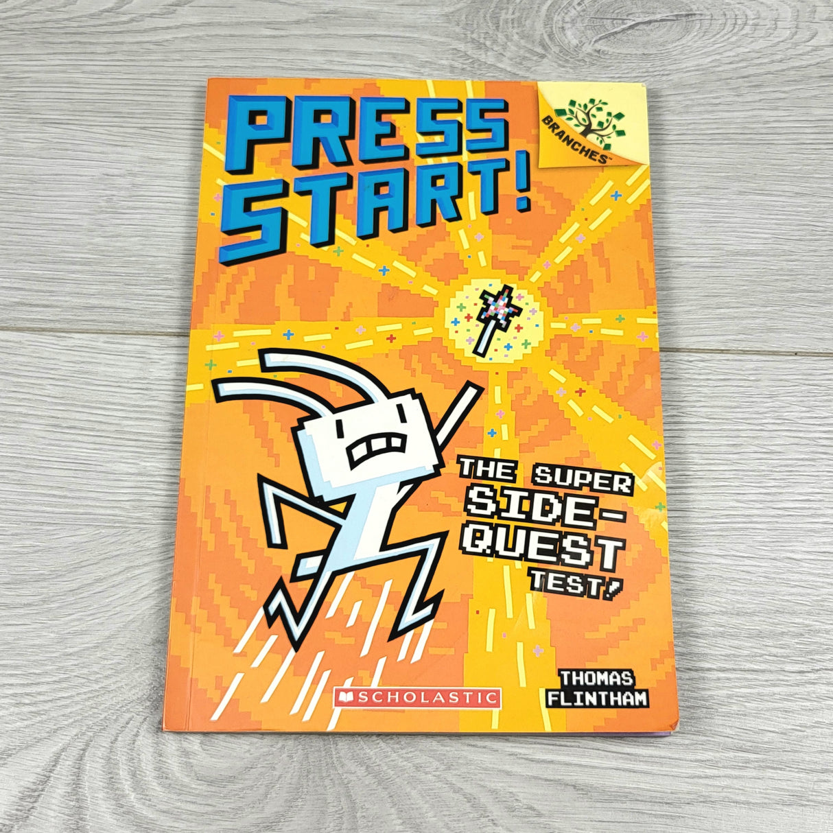 Press Start: The Super Side-Quest Test. Soft cover book