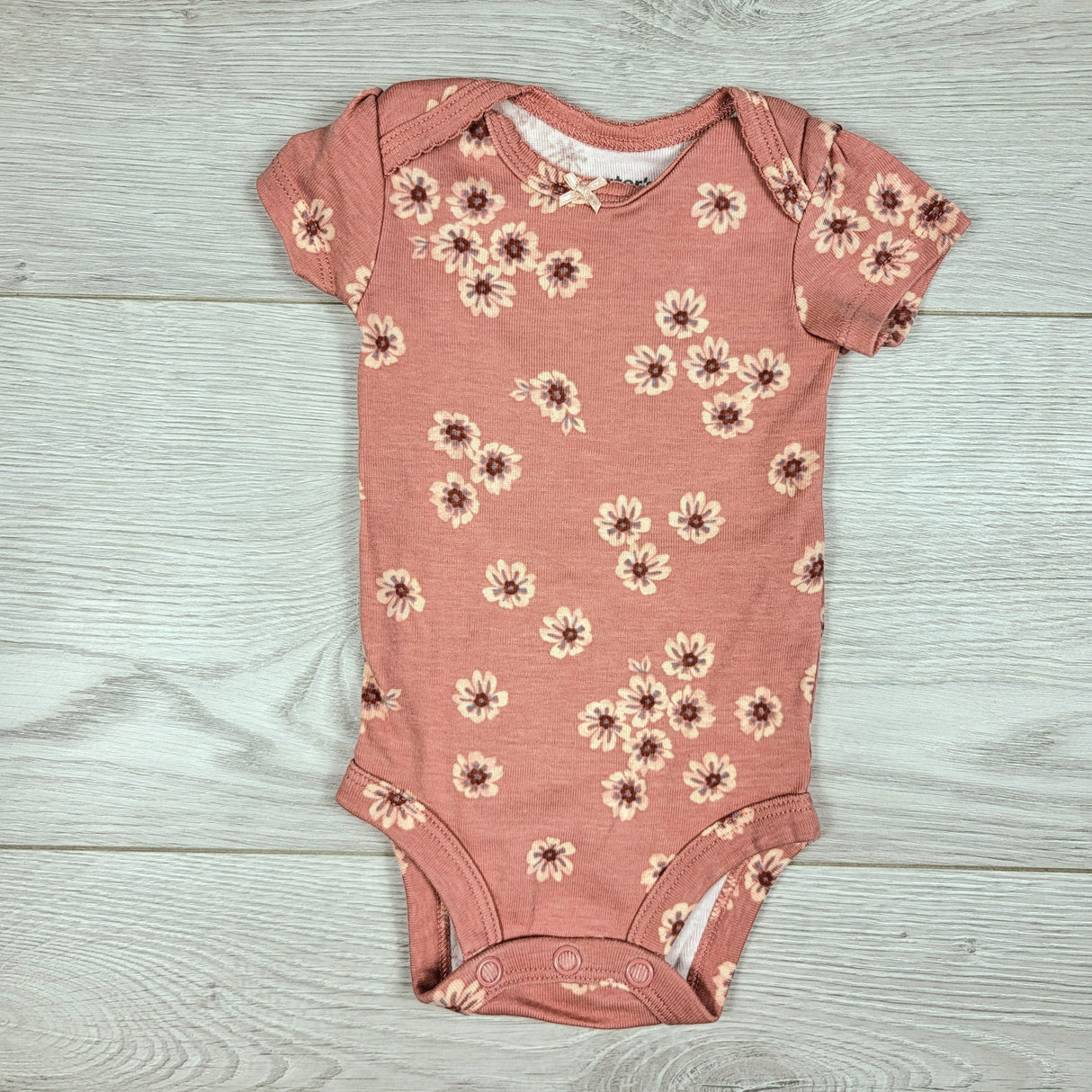 Carters pink bodysuit with flowers. Newborn size