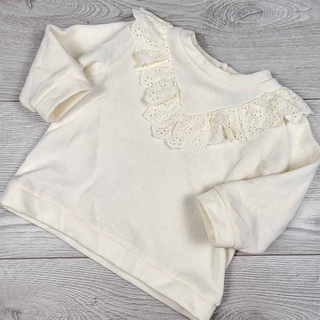 Nicole Miller cream coloured fleecy lined sweatshirt with ruffle. Size 6-9 months
