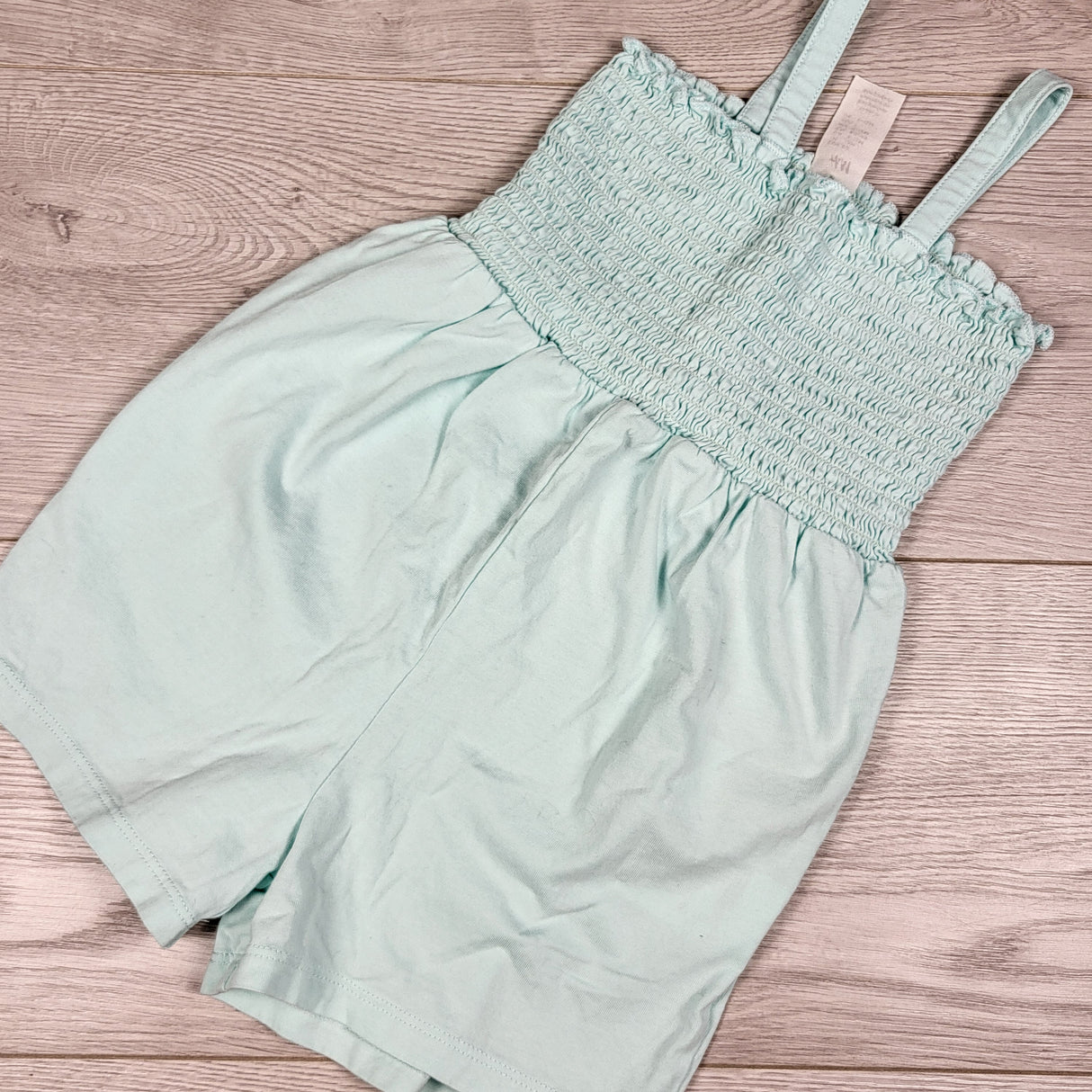 H and M turquoise smocked romper. Size 9-12 months