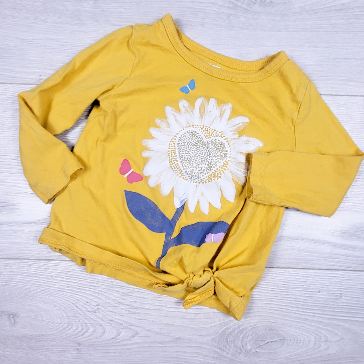 Carters yellow knotted top with flower. Size 12 months