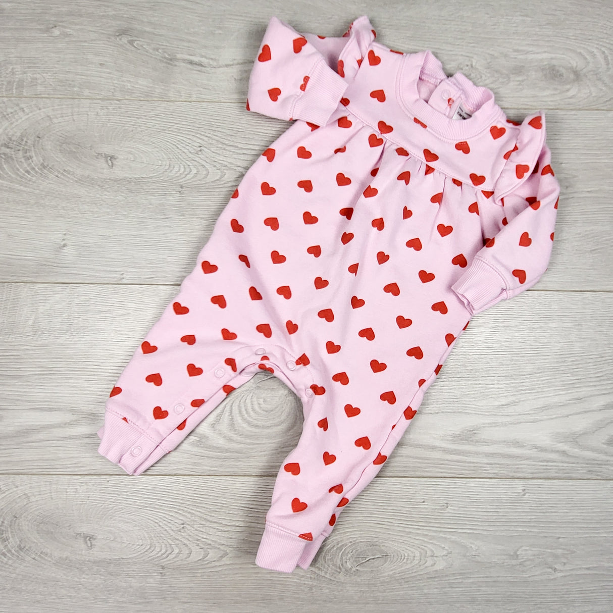 Carters pink fleecy lined sweatshirt romper with hearts. Size 6 months