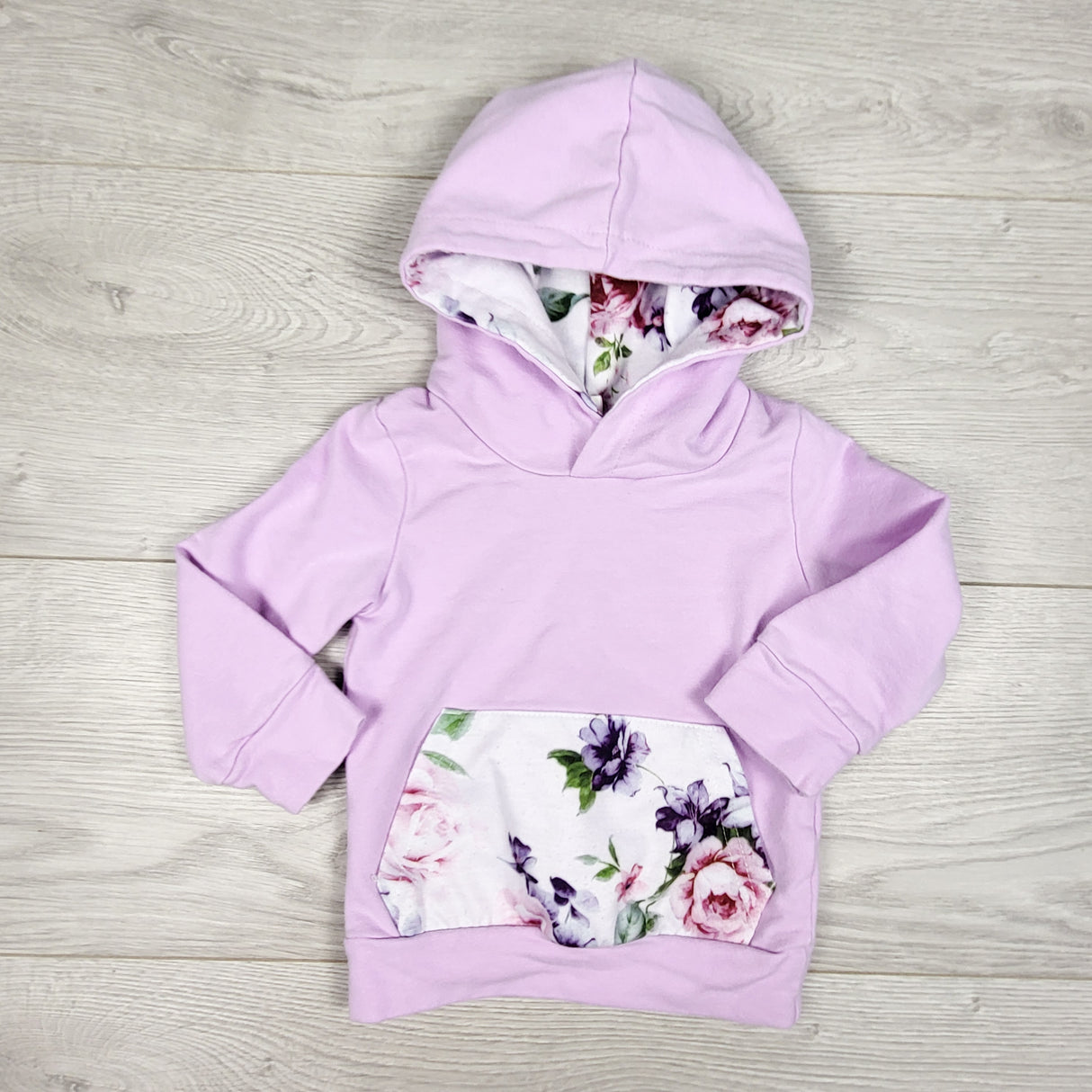 Purple pullover hoodie with floral accents. Size 6-12 months