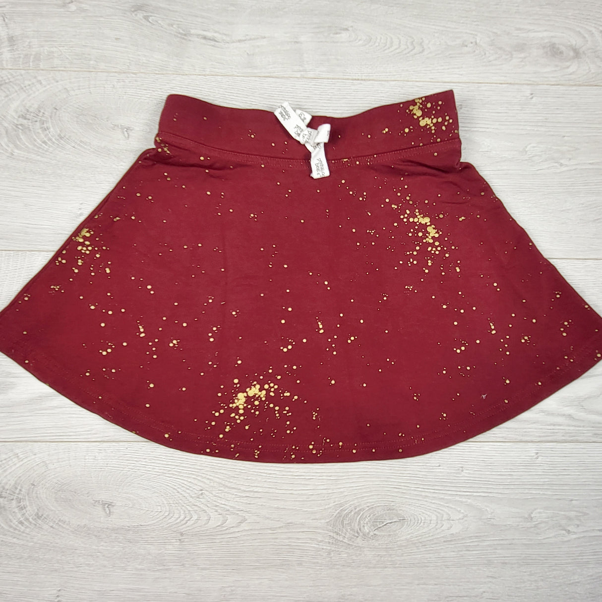 Peekaboo Beans burgundy and gold "sway skirt." Size 8