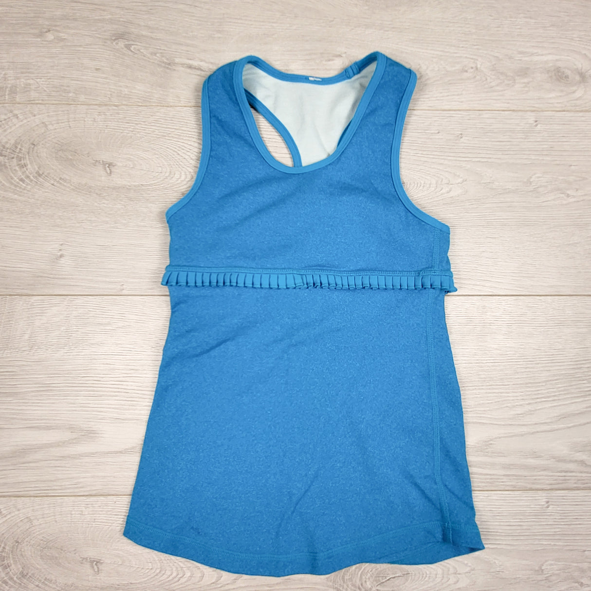 Ivivva (Lululemon) turquoise blue active tank with ruffle. Sizes like a 6