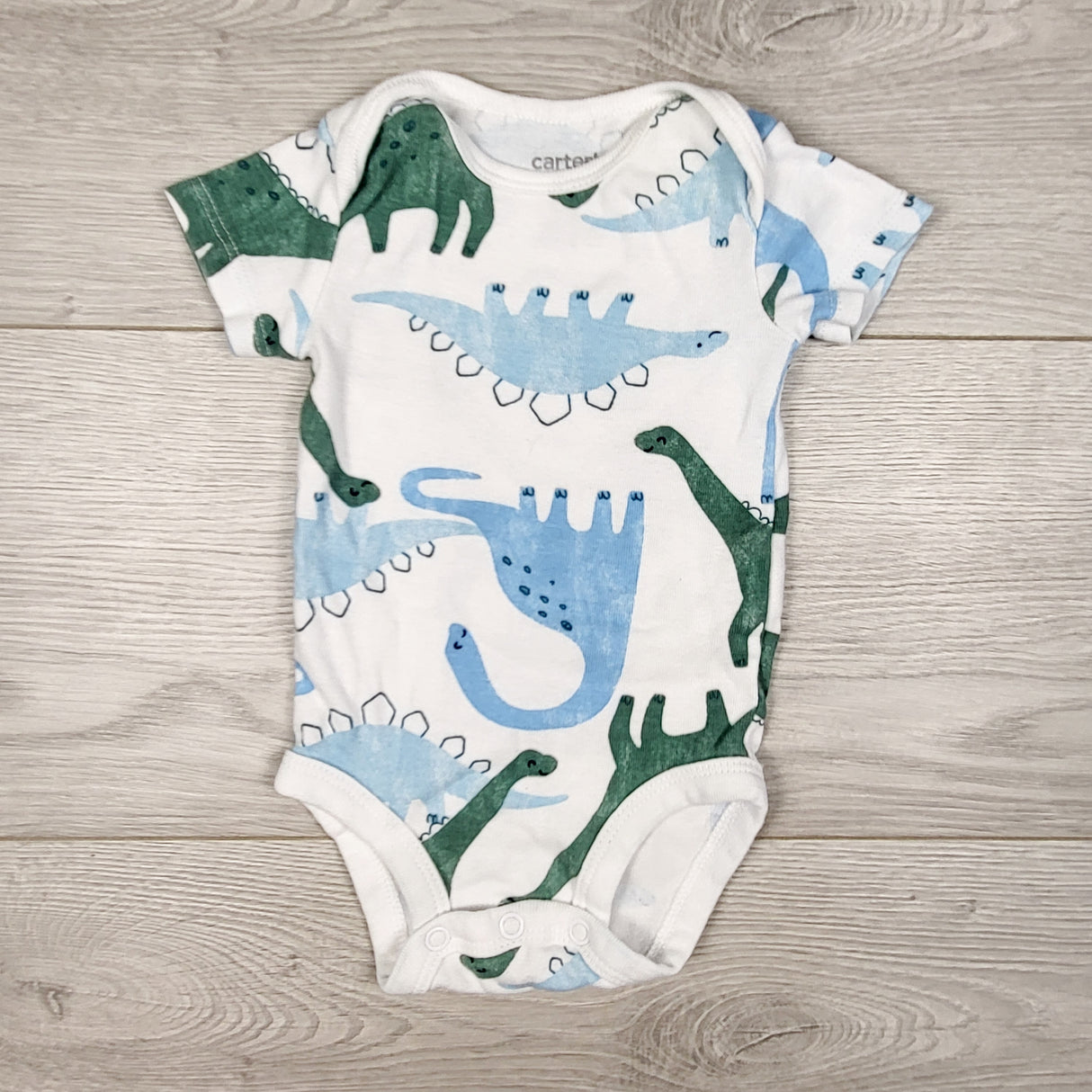 Child of Mine white dinosaur print bodysuit. Size 0-3 months