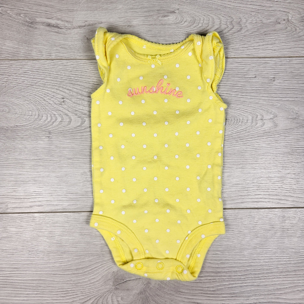 Carters yellow polka dot "Sunshine" bodysuit. Newborn size