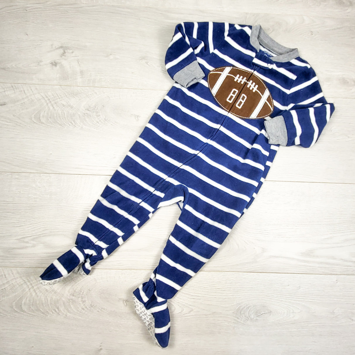 Carters navy striped fleece sleeper with football. Size 12 months