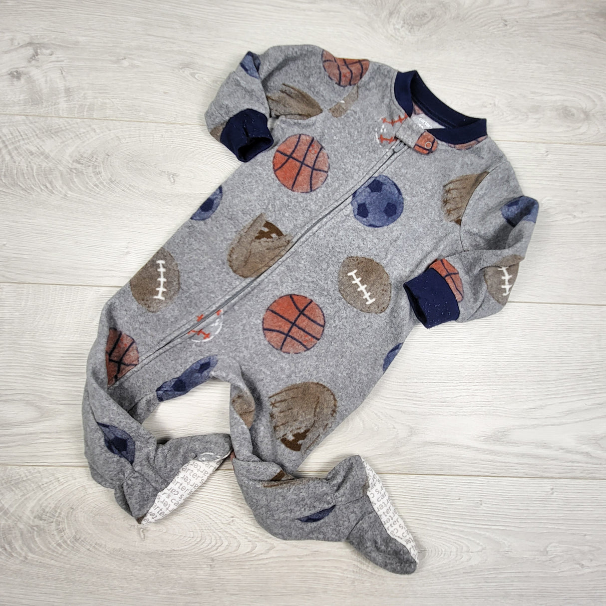 Carters grey zippered fleece sleeper with sports theme. Size 12 months