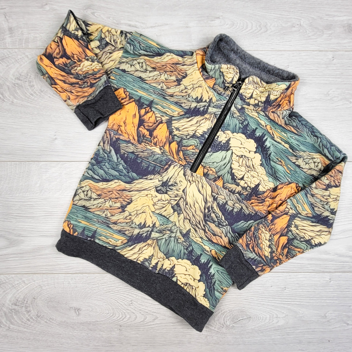 Handmade half-zip jacket with mountains. Approx 2T
