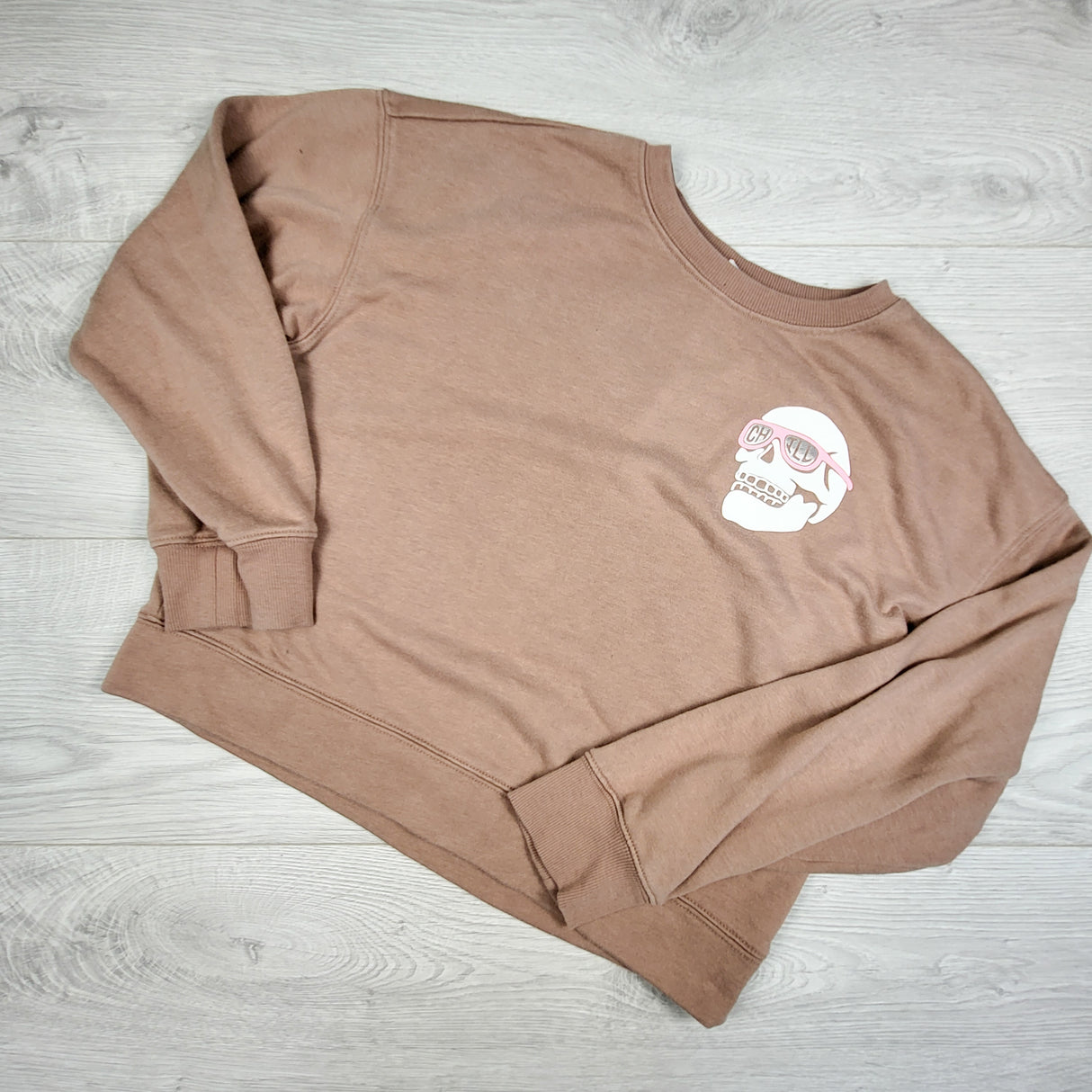 Old Navy tan cropped sweatshirt with skull. Size 10/12