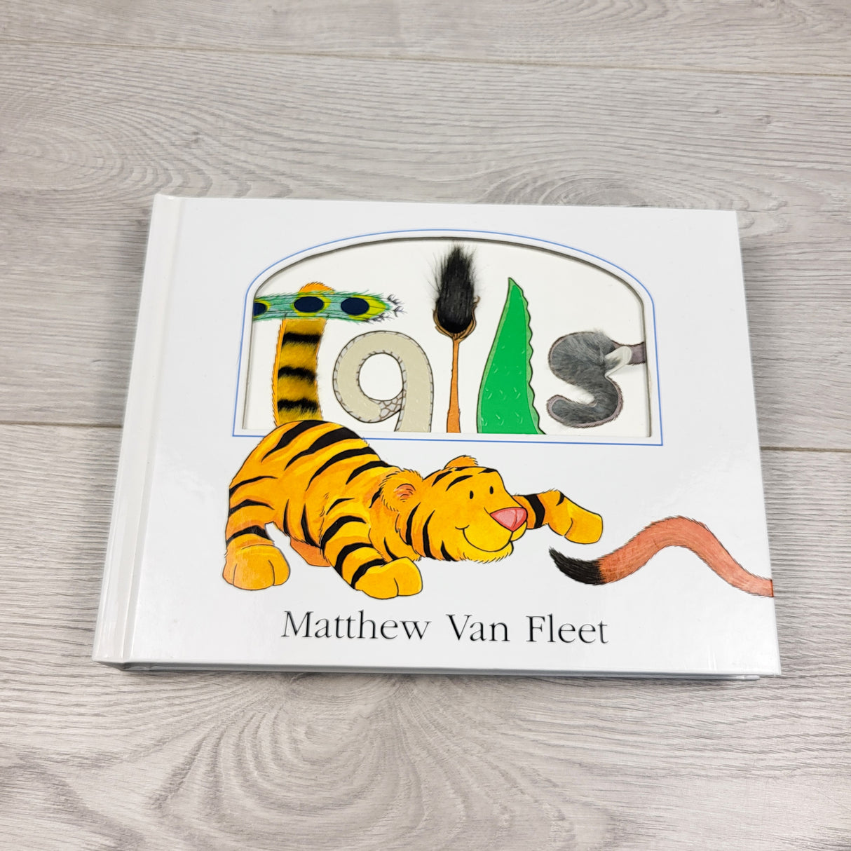 Tails. Hardcover sensory book with flaps, touch and feel, etc (sorry, no shipping)