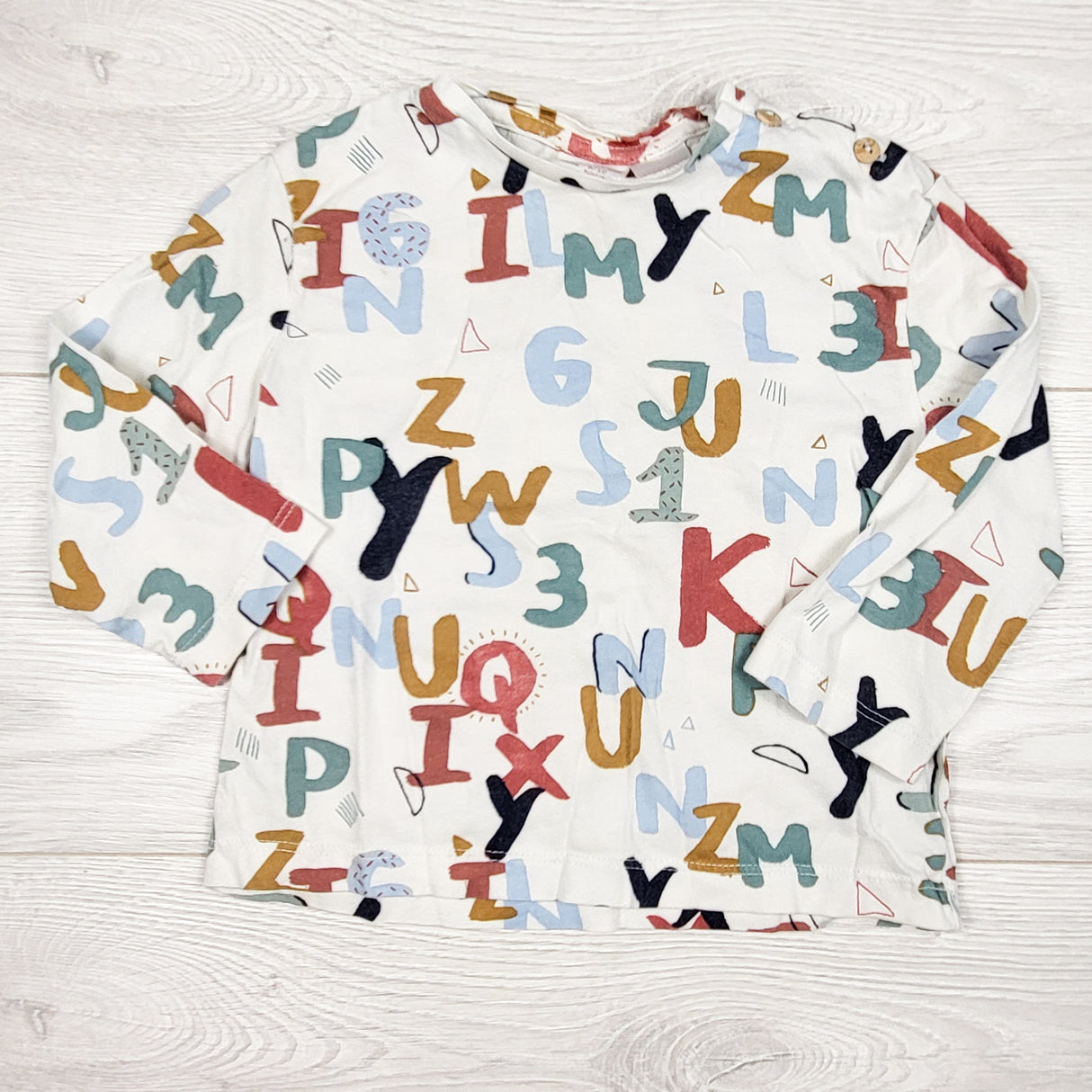 Zara white alphabet patterned long sleeve top. Size 9-12 months