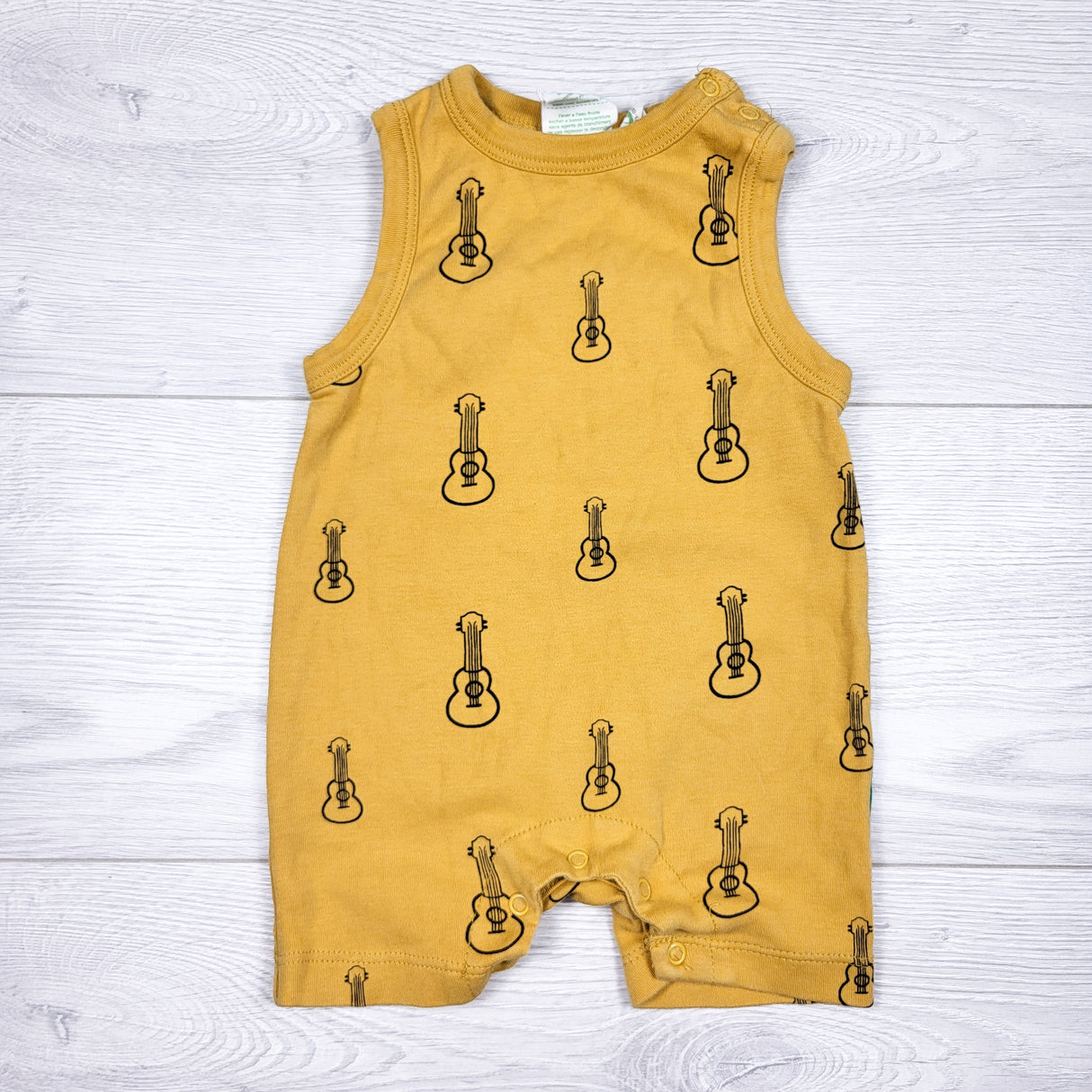 Parade yellow organic cotton romper with guitars. Size 3-6 months