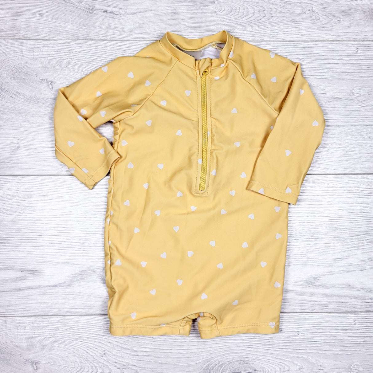 Rise Little Earthling yellow one piece rash guard with hearts. Size 6-12 months
