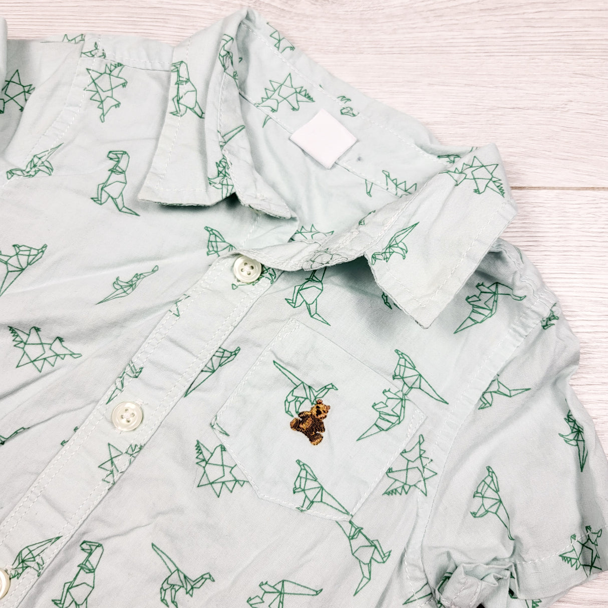 Gap green button down bodysuit with geometric dinosaurs. Size 18-24 months