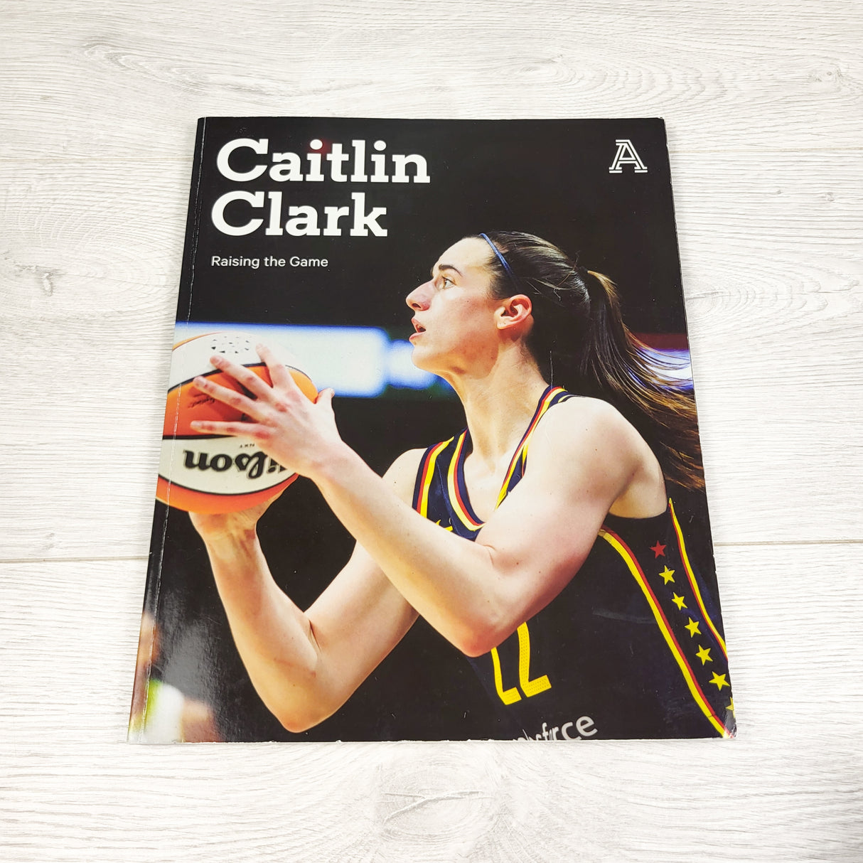 Caitlin Clark: Raising the Game. Soft cover book