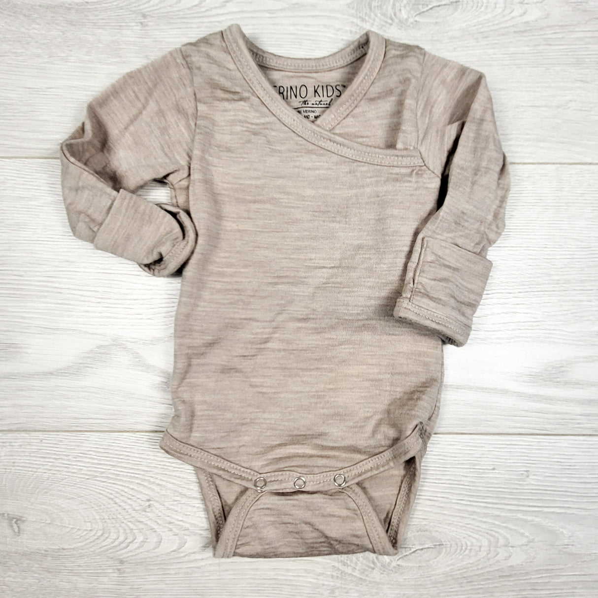 Merino Kids sand colour merino wool bodysuit. Size 0-3 months