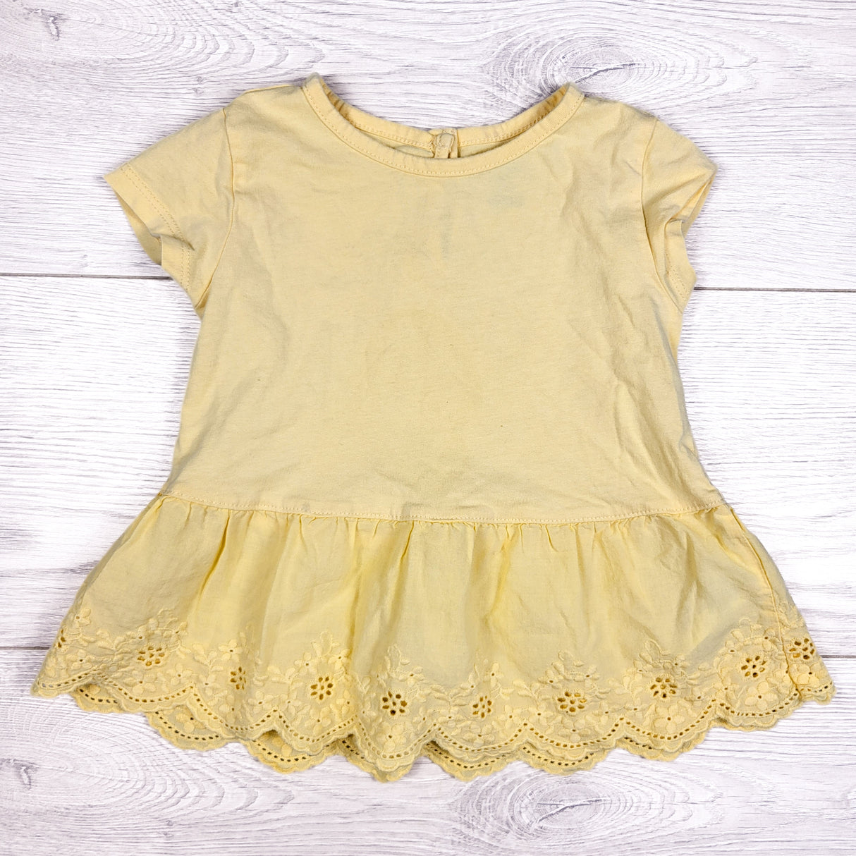Oshkosh yellow peplum top with eyelet detail. Size 2T