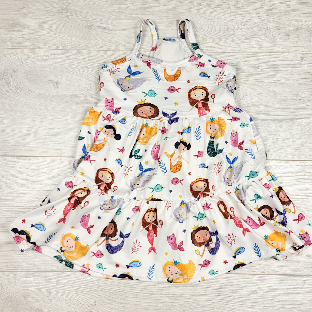 White sleeveless dress with mermaids. Approx 18-24 months