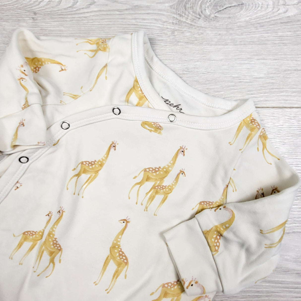 Pehr white organic cotton sleeper with giraffes.