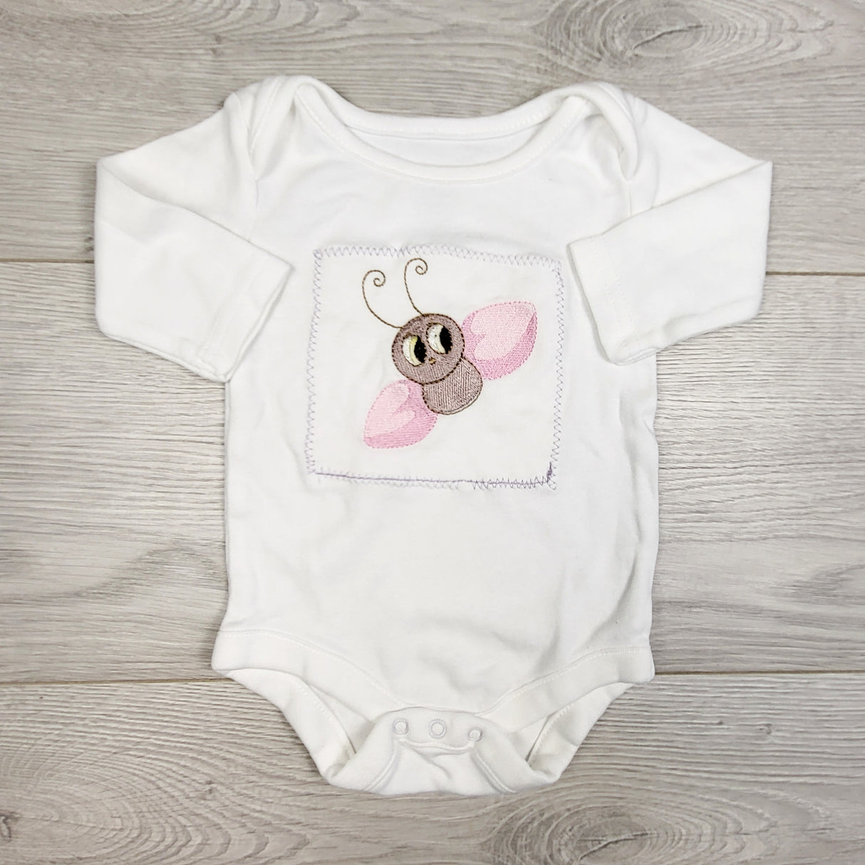 White custom bodysuit with embroidered bee (made on a George bodysuit.) Newborn size