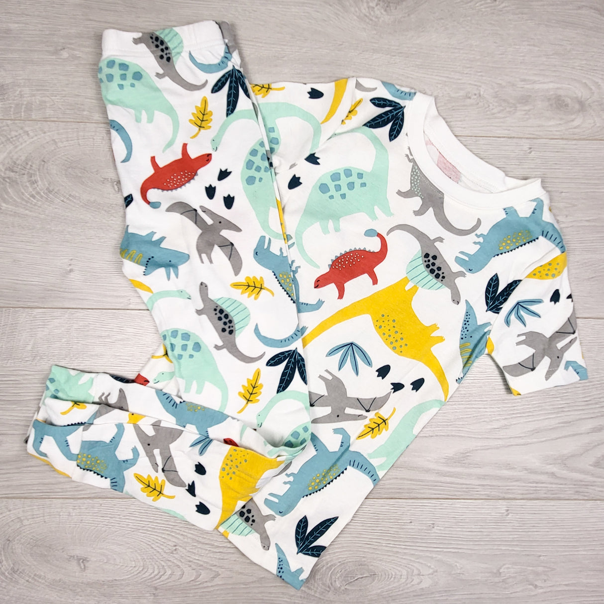Carters white 2pc PJs with dinosaurs. Size 7